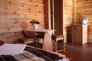 Una habitación con una mesa con un jarrón de flores. en Ośrodek Portus, en Międzywodzie