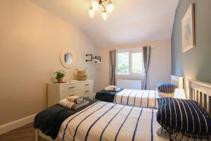 a bedroom with two beds and a window at The Piglets in Woodbridge