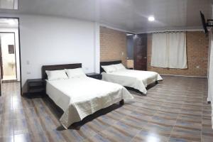CASA HOTEL VILLA Lorena tesisinde bir odada yatak veya yataklar