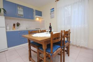 a kitchen with a table with a bottle of wine at Apartments by the sea Vis - 2459 in Vis