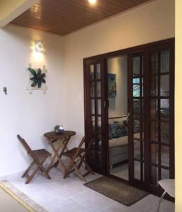 a room with a table and a glass door at Casa aluguel Abraão 1, Ar in Abraão