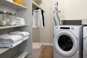 a laundry room with a washing machine and towels at Sentral Old Town in Scottsdale