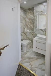 a bathroom with a white toilet and a sink at Horizon Hotel in Ayr