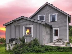 a gray house with a sunset in the window at 6 person holiday home in Olderdalen in Olderdalen