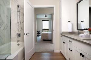 a bathroom with a shower and a sink and a tub at Sentral Old Town in Scottsdale