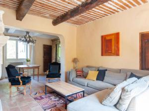 a living room with a couch and a table at Bastide with pool and panoramic views in Ménerbes