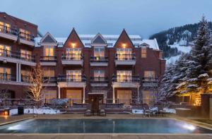 a large building with a pool in front of it at Aspen Mountain Residences, 2 Bedroom Luxury Residence Club Condo in Aspen