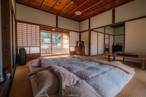 a large bed in the middle of a room at Japan's oldest remaining company housing in Ikuno
