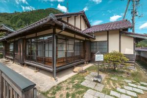 a house with a sign in front of it at Japan's oldest remaining company housing in Ikuno