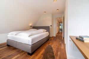 Ένα ή περισσότερα κρεβάτια σε δωμάτιο στο Villa Westküste