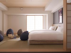 a bedroom with a large bed and a window at MIMARU OSAKA SHINSAIBASHI EAST in Osaka