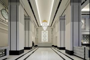 a hallway of a building with a chandelier at KOKO HOTEL Premier Nihonbashi Hamacho in Tokyo