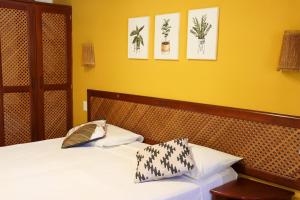 a bedroom with a bed with two pillows on it at Hotel Vento Brasil in Paracuru