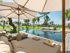 an image of a resort pool with umbrellas at Kaba Kaba Estate in Tabanan