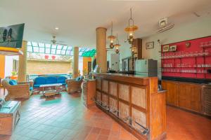a lobby with a bar and a living room at Evergreen boutique Hua Hin in Hua Hin
