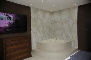 a large bathroom with a tub and a tv at Hotel Posada Santa Fe Sabinas in Sabinas +100 photos