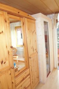 a room with a wooden cabinet and a window at Haus Bergwelt in Grän