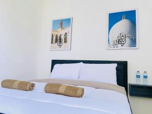 Postel nebo postele na pokoji v ubytování Ameera Patra Kuningan