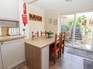 a kitchen with a table and chairs and a window at Riverlea in Rhyl