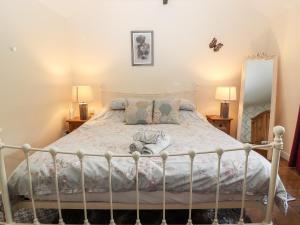 a bedroom with a bed with a white bed frame at Riverlea in Rhyl