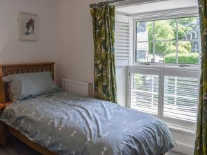 a bedroom with a bed and a large window at Bryn Y Felin in Dyffryn