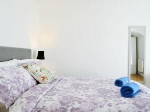 ein Schlafzimmer mit einem Bett mit blauen Handtüchern darauf in der Unterkunft Ty Bryn Cottage in Kenfig Hill