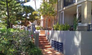 a stairway leading to a house with palm trees at Beaches On Wave Street in Gold Coast +5 photos