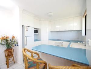 a kitchen with a large blue counter in it at Hi Surf Unit 2, 92 Head Street, Forster in Forster