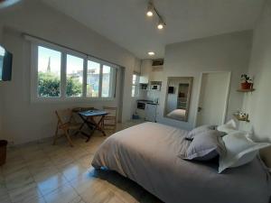 a bedroom with a large bed and a table in it at Apartamento centrico in Buenos Aires