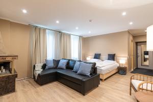 a living room with a bed and a couch at Dandelion Apartments Baznīcas in Rīga