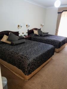 Ένα ή περισσότερα κρεβάτια σε δωμάτιο στο Australian Heritage Motor Inn