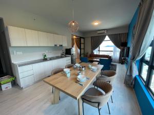 a kitchen and dining room with a wooden table and chairs at SEAVIEW LUXURY CONDO HOMESTAY 2Bed 2bath Jesselton Quay by R2 Residence in Kota Kinabalu