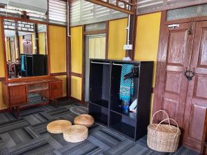 a room with a tv and two baskets on the floor at Kejora Homestay in Kangar