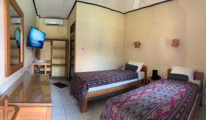 Postel nebo postele na pokoji v ubytování Prambanan Guesthouse