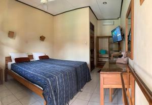 Postel nebo postele na pokoji v ubytování Prambanan Guesthouse