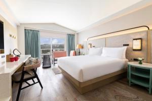 Crowne Plaza Resort Saipan في غارابان: غرفة الفندق بسرير كبير ومكتب