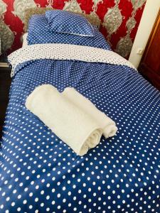 a blue and white bed with a heart shaped towel on it at Budapest Diamond Flat in Budapest