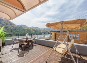 a balcony with a table and chairs and a view at Riversky Pension in Gapyeong