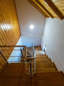 a staircase in a room with a chair in it at Pensiunea Eric in Curtea de Argeş