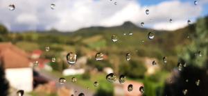 a close up of a window with raindrops on it at Pensiunea Casa Motilor in Bucium
