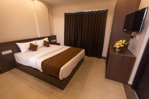 Ένα ή περισσότερα κρεβάτια σε δωμάτιο στο HOTEL PANKAJ RESIDENCY