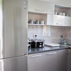 a kitchen with a stainless steel refrigerator at Klaudia Vendégház in Mórahalom