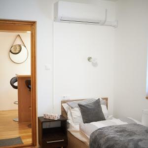1 dormitorio con 1 cama y ventilador de techo en Klaudia Vendégház en Mórahalom