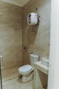 a bathroom with a toilet and a sink at DS Colive Layur Kota Lama in Semarang