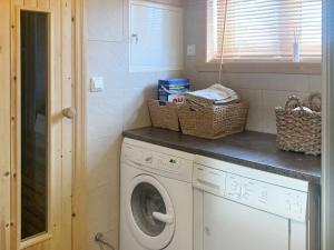 a laundry room with a washing machine and baskets on the counter at Holiday home Byrkjelo in Byrkjelobrua