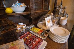 a table with some food and plates on it at Hotel Villa Glas in Erlangen