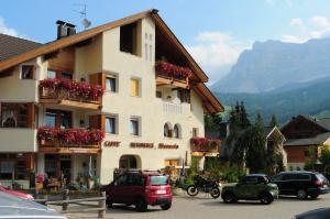 a building with flowers on the balconies in a town at residence Manuela in La Villa +6 photos