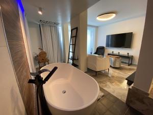 a bathroom with a white sink and a living room at daniela in Eilat
