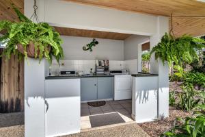 an outdoor kitchen with white appliances and plants at Mission Beach Shores in Mission Beach