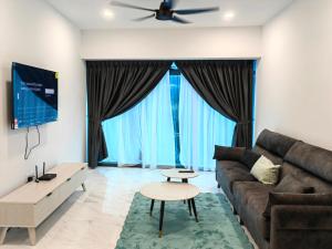 a living room with a couch and a table at Eaton Residences KLCC by Luna in Kuala Lumpur